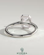 Kynora CJ statement 2ct emerald bezel solitaire engagement ring with open cathedral high setting showcasing a large central emerald gemstone.