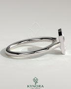 Kynora CJ statement 2ct emerald bezel solitaire engagement ring with open cathedral high setting, showcasing a central green emerald gemstone.