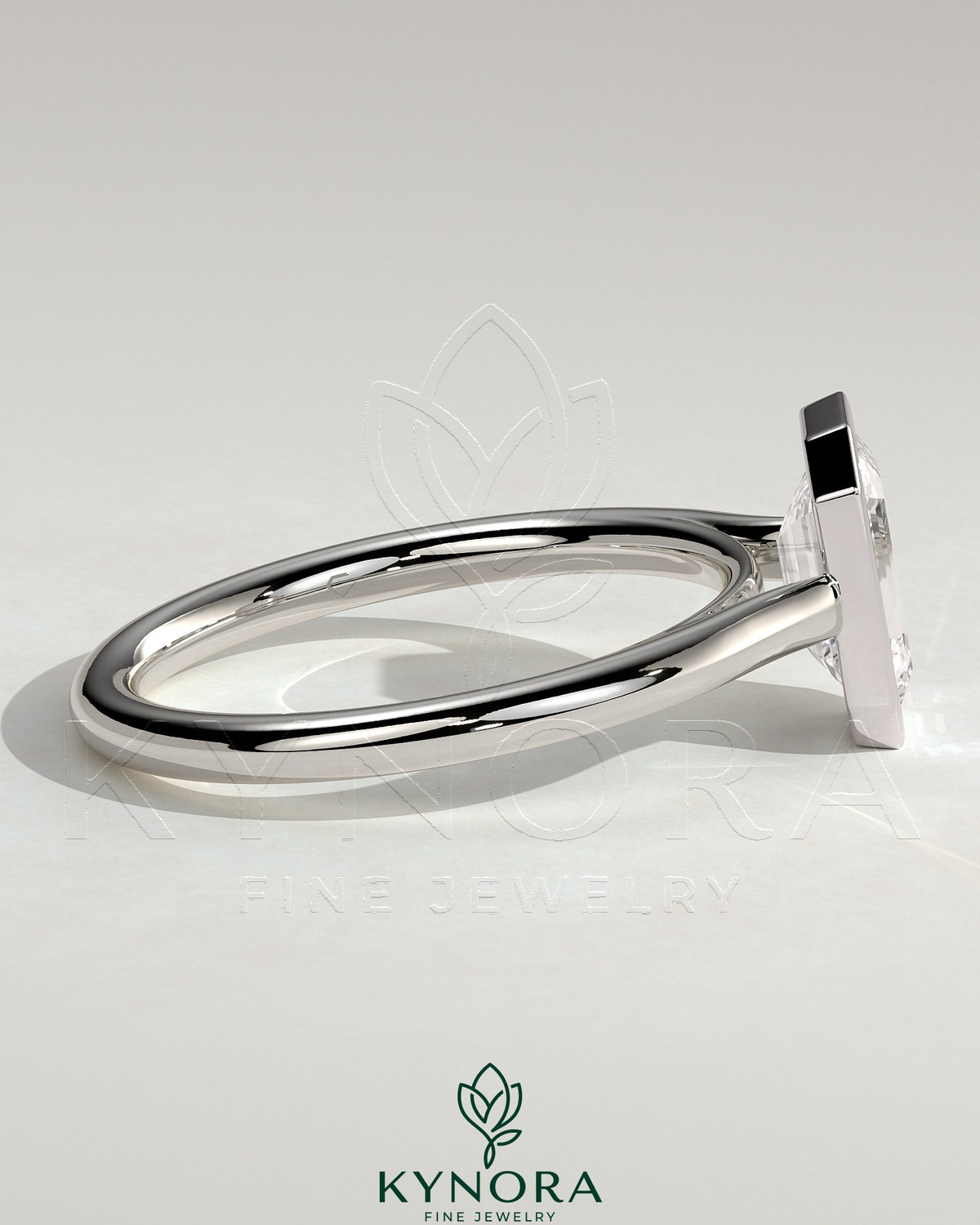 Kynora CJ statement 2ct emerald bezel solitaire engagement ring with open cathedral high setting, showcasing a central green emerald gemstone.