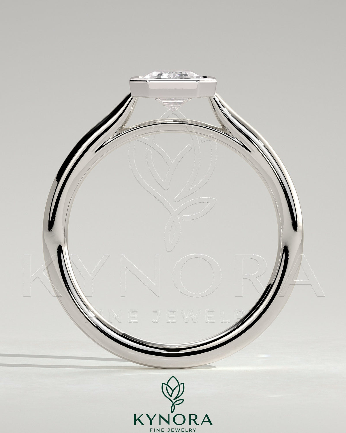 Kynora CJ statement 2ct emerald bezel solitaire engagement ring with open cathedral high setting, showcasing a vibrant green gemstone.