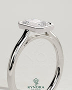 Kynora CJ statement 2ct emerald bezel solitaire engagement ring with open cathedral high setting, showcasing detailed craftsmanship.