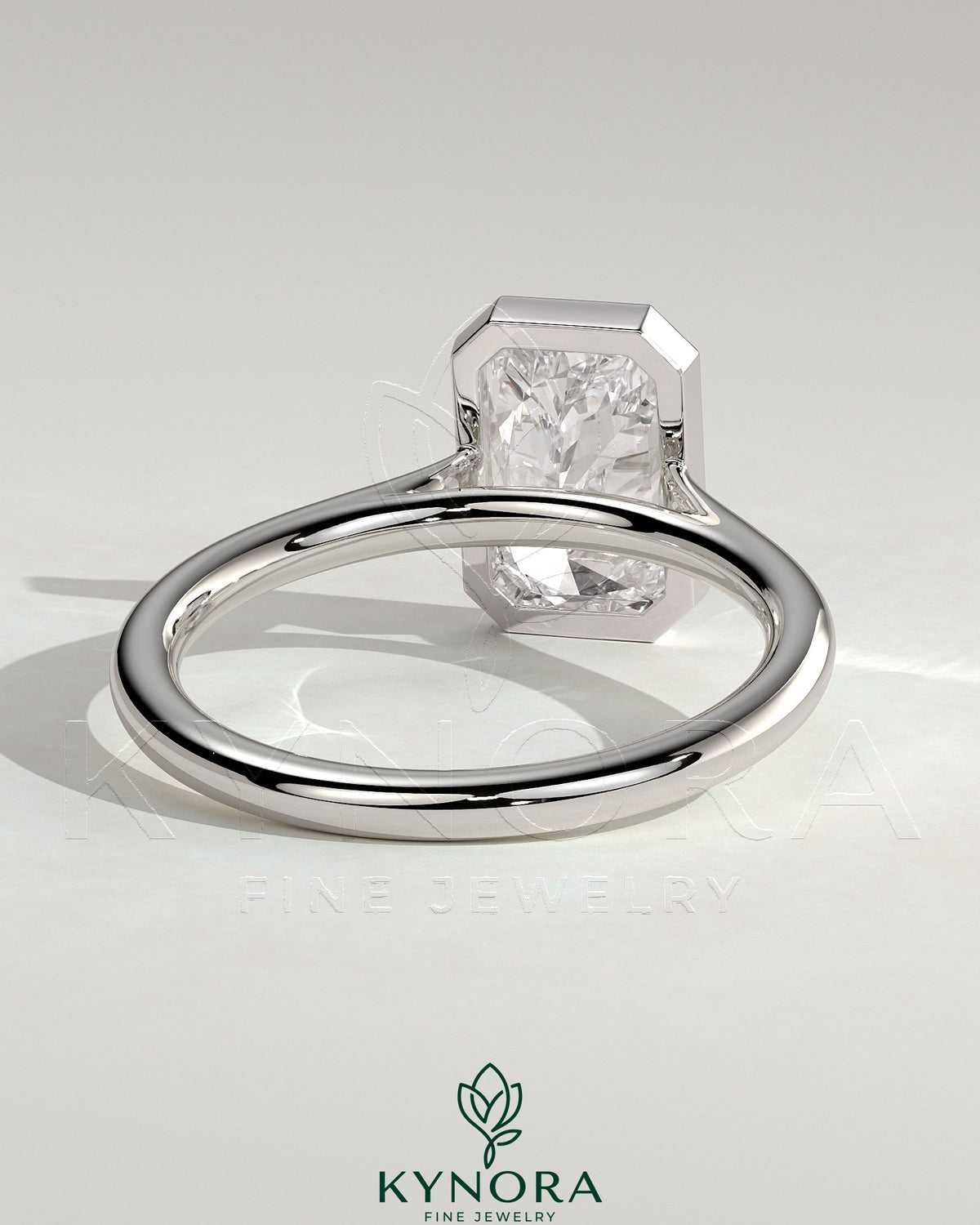 Kynora CJ statement 2ct radiant bezel solitaire engagement ring with open cathedral high setting, showcasing elegant diamond design.