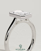 Kynora CJ statement 2ct radiant bezel solitaire engagement ring with open cathedral high setting, showcasing a sparkling center gemstone.