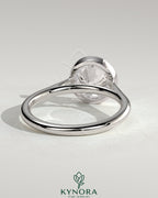 Kynora CJ statement 2ct round bezel solitaire engagement ring with open cathedral high setting, showcasing elegant jewelry design