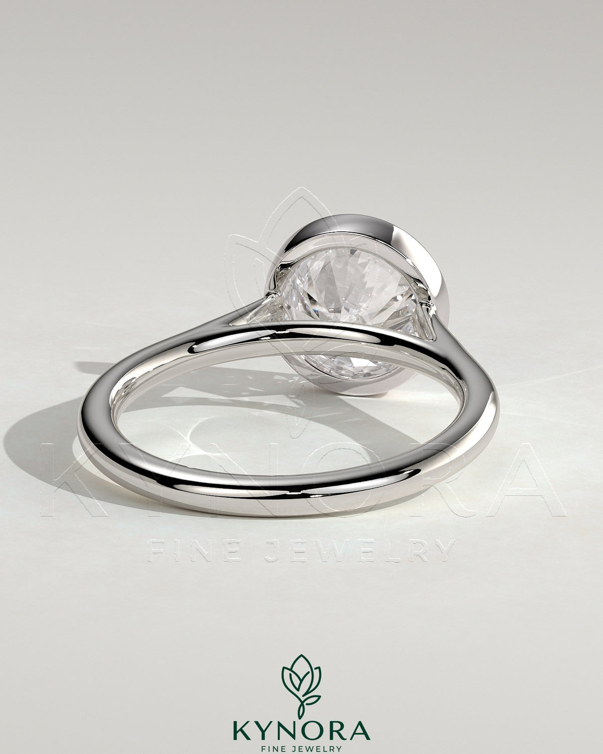 Kynora CJ statement 2ct round bezel solitaire engagement ring with open cathedral high setting, showcasing elegant jewelry design