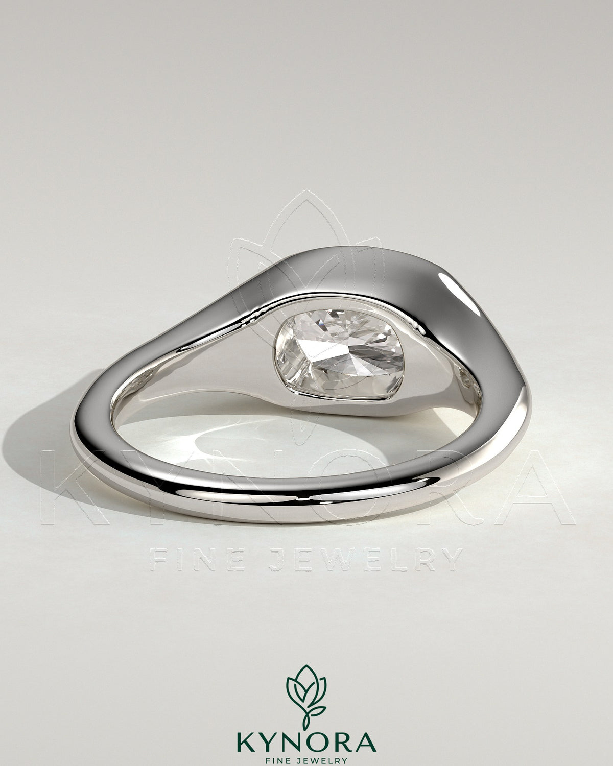 Kynora CJ 2ct elongated cushion cut diamond engagement ring with east-west bezel solitaire and signet band design.