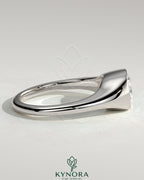 Kynora CJ 2ct elongated east-west bezel solitaire engagement ring with signet band, showcasing a sparkling diamond and sleek gold band.