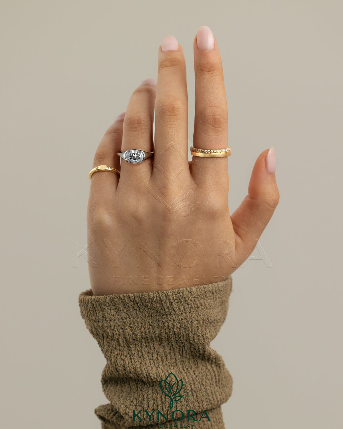 Kynora CJ 2ct elongated cushion East-West bezel solitaire engagement ring with signet band, showcasing a sparkling center stone.