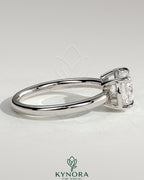 East-West 2ct cushion-shaped diamond solitaire engagement ring with bezel frame by Kynora CJ, featuring a sleek, elongated design.