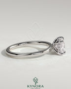 Kynora CJ 2ct elongated East-West cushion cut engagement ring with hidden halo and claw setting, showcased on a white background.