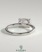 Kynora CJ 2ct elongated cushion east-west claw solitaire engagement ring with raised basket gallery design.