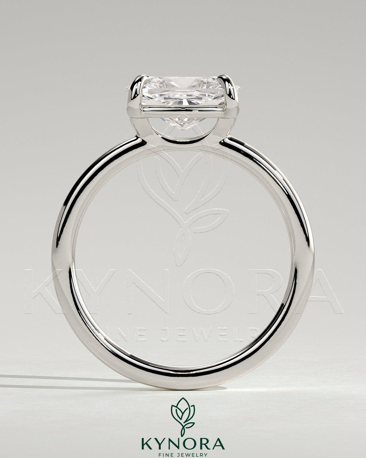 Kynora CJ 2-carat elongated east-west claw solitaire engagement ring with raised basket gallery, sparkling diamond setting.