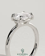 Kynora CJ 2ct elongated East-West cushion solitaire engagement ring with raised basket gallery and claw setting.