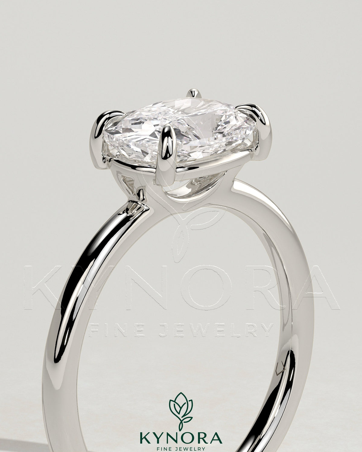 Kynora CJ 2ct elongated East-West cushion solitaire engagement ring with raised basket gallery and claw setting.