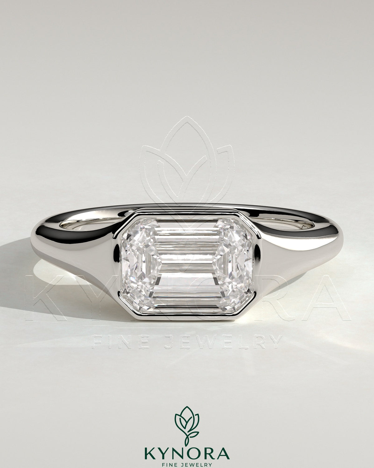 Kynora CJ 2ct emerald east-west bezel solitaire engagement ring with signet band showcasing a vibrant green emerald gemstone. Imagen principal del producto