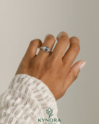 Kynora CJ 2ct emerald east-west bezel solitaire engagement ring with signet band, featuring a striking emerald gemstone.