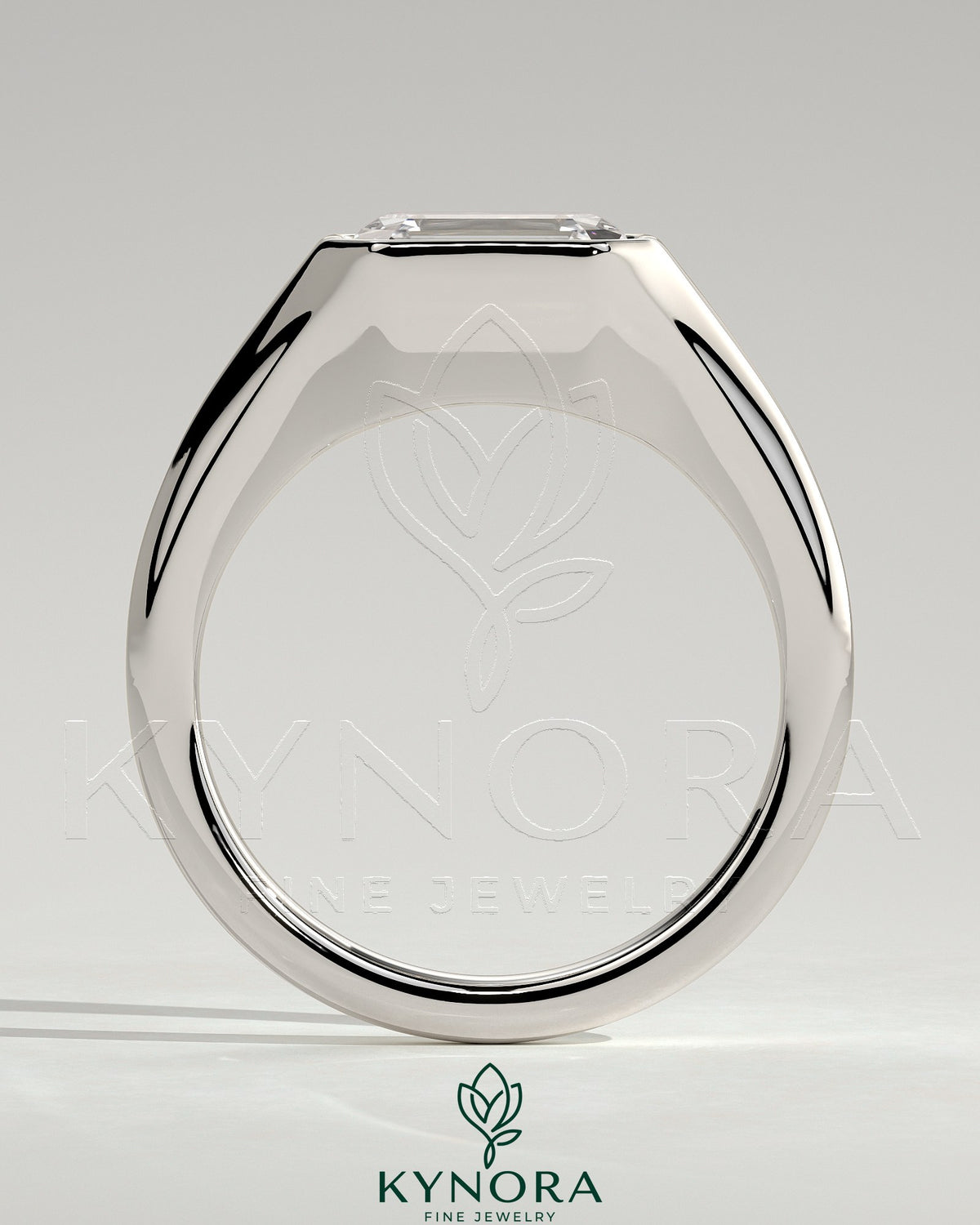 East-West 2ct emerald engagement ring by Kynora CJ featuring a bezel solitaire setting and signet band design.