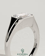 Kynora CJ 2ct emerald cut east-west bezel solitaire engagement ring with signet band featuring a central emerald gemstone.