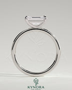 Kynora CJ 2ct emerald cut east-west claw solitaire engagement ring with platinum band and secure prong setting.