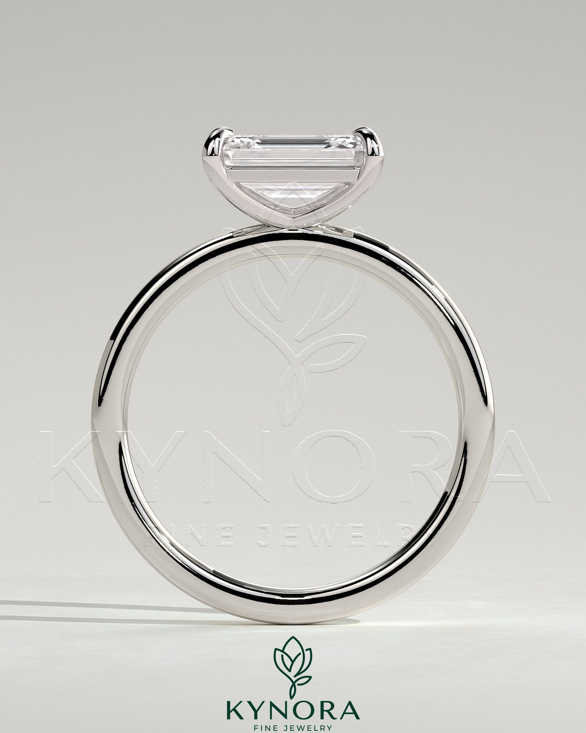 Kynora CJ 2ct emerald cut east-west claw solitaire engagement ring with platinum band and secure prong setting.