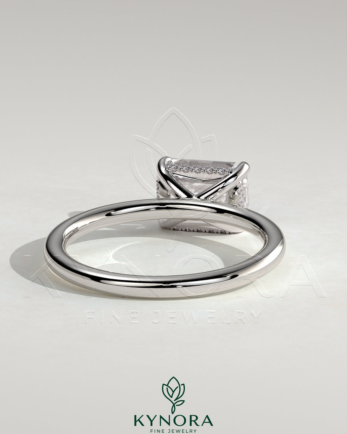 Kynora CJ 2ct emerald-cut east-west claw solitaire engagement ring with hidden halo, featuring a stunning emerald gemstone.