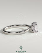 Kynora CJ 2ct emerald cut east-west claw solitaire engagement ring with hidden halo and diamond accents on a silver band.
