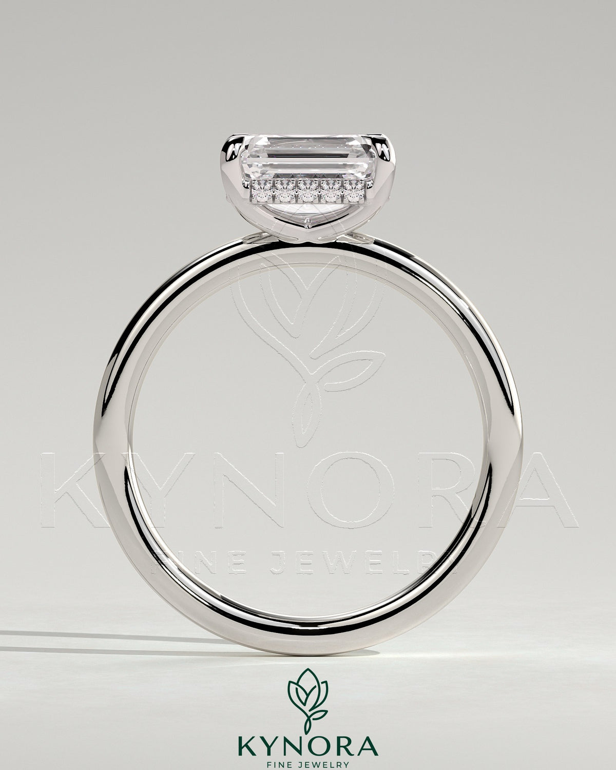 Kynora CJ 2ct emerald cut east-west claw solitaire engagement ring with hidden halo, showcasing a sparkling center stone and elegant design.
