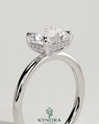 Kynora CJ 2ct emerald cut East-West claw solitaire engagement ring with hidden halo, showcasing elegant diamond setting.