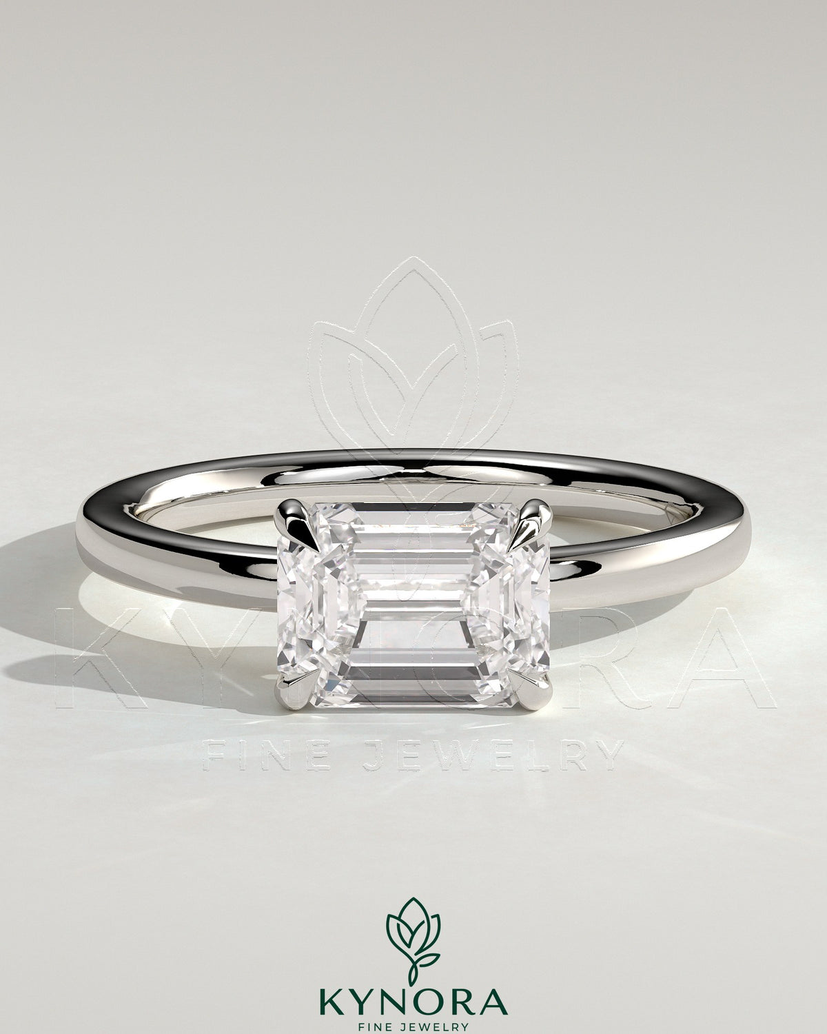 Kynora CJ 2ct emerald east-west claw solitaire engagement ring with raised basket gallery and intricate metalwork design Main image