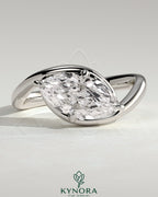 Kynora CJ 2ct marquise east-west claw solitaire engagement ring with bypass band, featuring a sparkling marquise-shaped diamond.