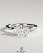 Kynora CJ 2ct oval east-west claw solitaire engagement ring with four prongs, showcasing a sparkling oval diamond design.