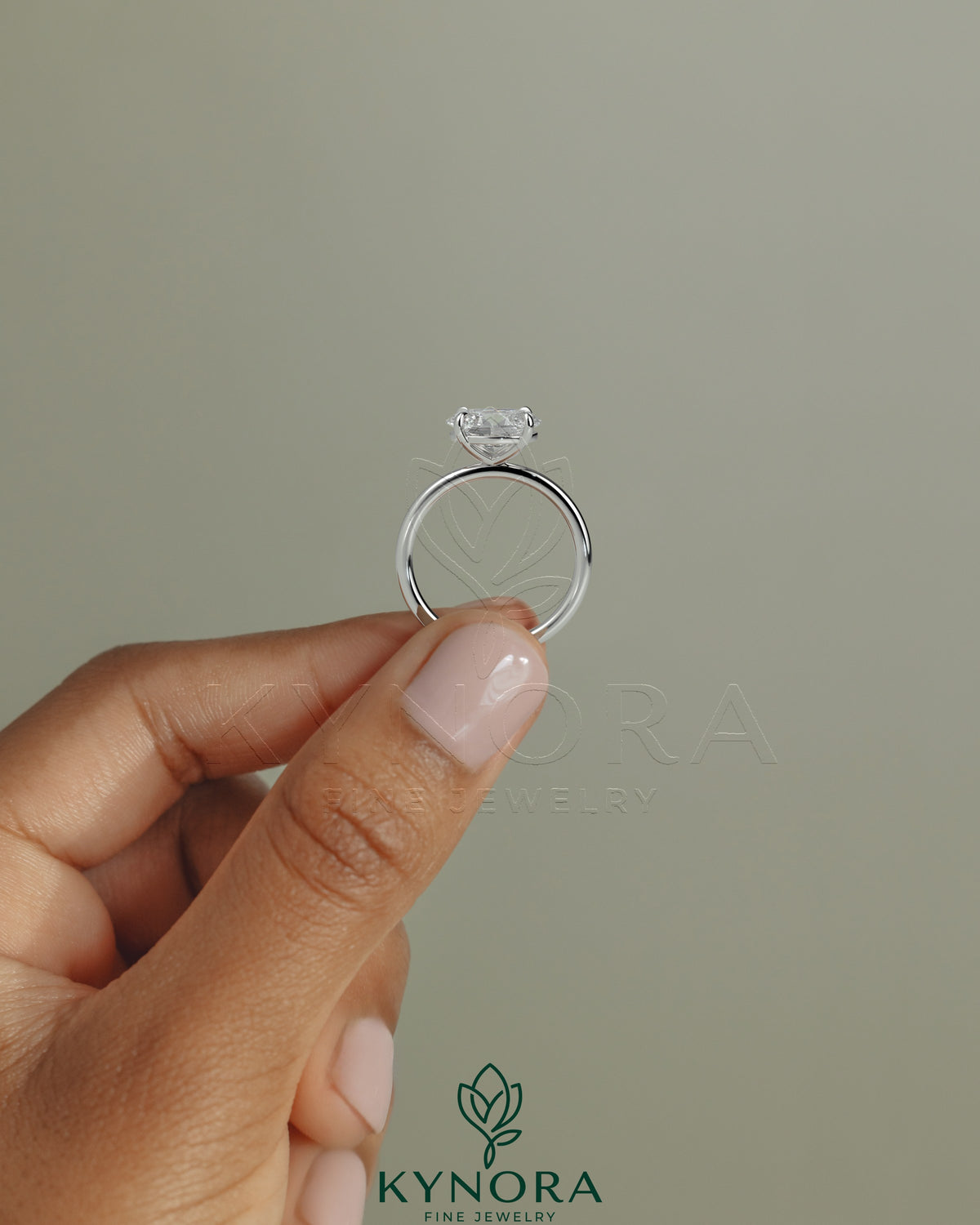 Kynora CJ 2ct oval east-west claw solitaire engagement ring with four prongs, featuring a sparkling central diamond.