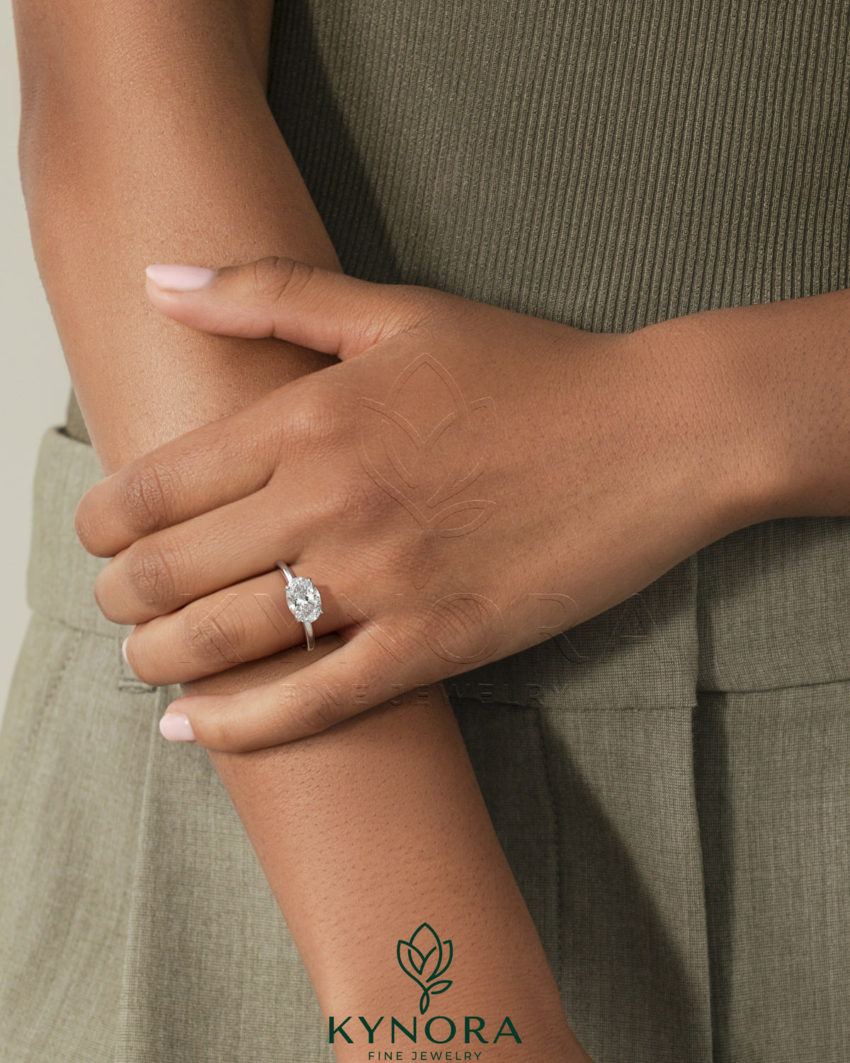 Kynora CJ 2ct oval east-west claw solitaire engagement ring with four prongs, featuring a sparkling diamond on a sleek band.