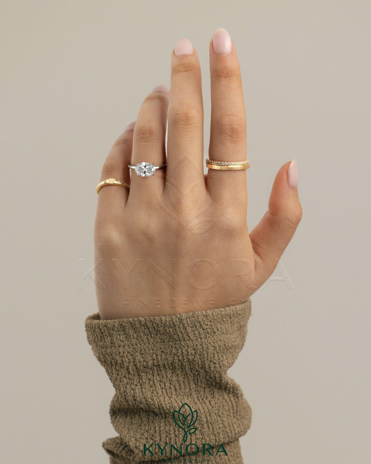 Kynora CJ 2ct oval east-west claw solitaire engagement ring with four prongs showcasing a prominent gemstone on a sleek band.