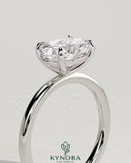 Kynora CJ 2ct oval east-west claw solitaire engagement ring with four prongs, showcasing a sparkling center diamond.