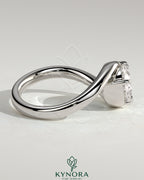 Kynora CJ 2ct oval east-west claw solitaire engagement ring with bypass band, showcasing a sparkling central diamond and elegant design.
