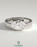 Kynora CJ 2ct oval offset east-west claw solitaire engagement ring with flat cigar band, showcasing a sparkling diamond setting.