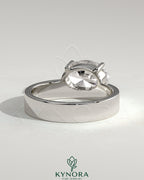 Kynora CJ 2ct oval offset East-West claw solitaire engagement ring with flat cigar band showcasing a sparkling center stone and sleek band.