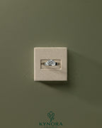 Kynora CJ 2ct oval offset east-west claw solitaire engagement ring with flat cigar band, featuring a sparkling central gemstone.