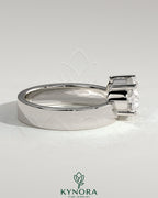 Kynora CJ 2ct oval offset east-west claw solitaire engagement ring with flat cigar band in gold.
