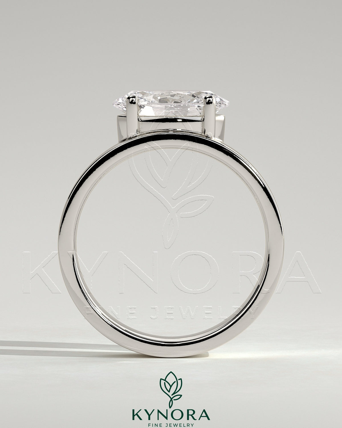 Kynora CJ 2ct oval offset east-west claw solitaire engagement ring with flat cigar band, showcasing a sparkling diamond and elegant design.