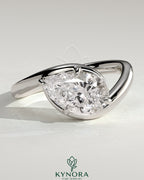 Kynora CJ 2ct pear-shaped east-west diamond solitaire engagement ring with bypass band in yellow gold.