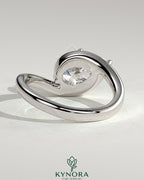 Kynora CJ 2ct pear-shaped east-west claw solitaire engagement ring with bypass band featuring a sparkling diamond.