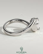 Kynora CJ 2ct pear-shaped east-west diamond solitaire engagement ring with bypass band in gold, showcasing intricate design details.