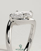 East-West 2ct pear-shaped diamond solitaire engagement ring with bypass band by Kynora CJ, showcasing elegant craftsmanship and sparkle.