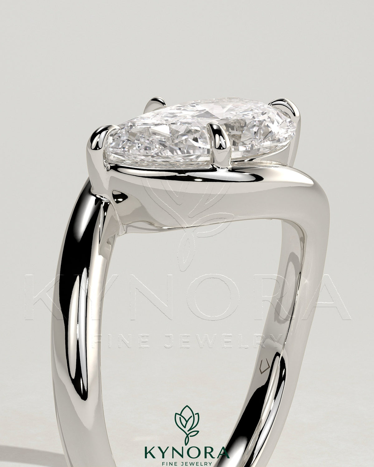 East-West 2ct pear-shaped diamond solitaire engagement ring with bypass band by Kynora CJ, showcasing elegant craftsmanship and sparkle.