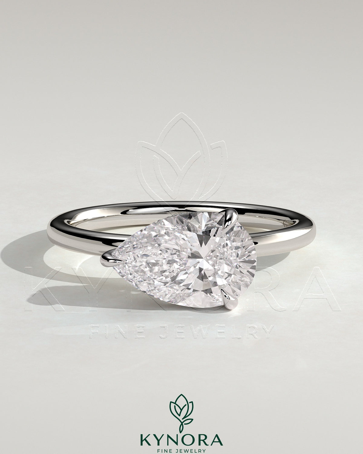 Kynora CJ 2-carat pear-shaped east-west claw solitaire engagement ring with hidden halo and elegant design. Imagen principal del producto