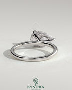 Kynora CJ 2ct pear-shaped east-west claw solitaire engagement ring with hidden halo, showcasing sparkling diamond design.