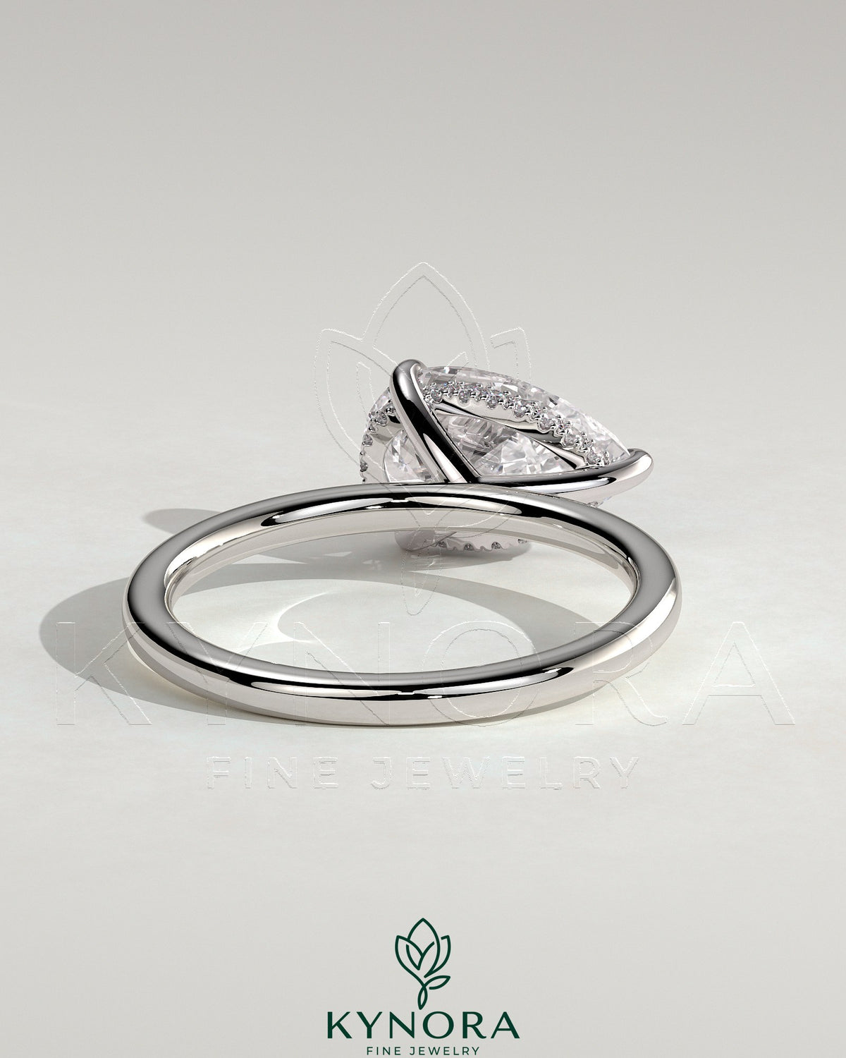 Kynora CJ 2ct pear-shaped east-west claw solitaire engagement ring with hidden halo, showcasing sparkling diamond design.