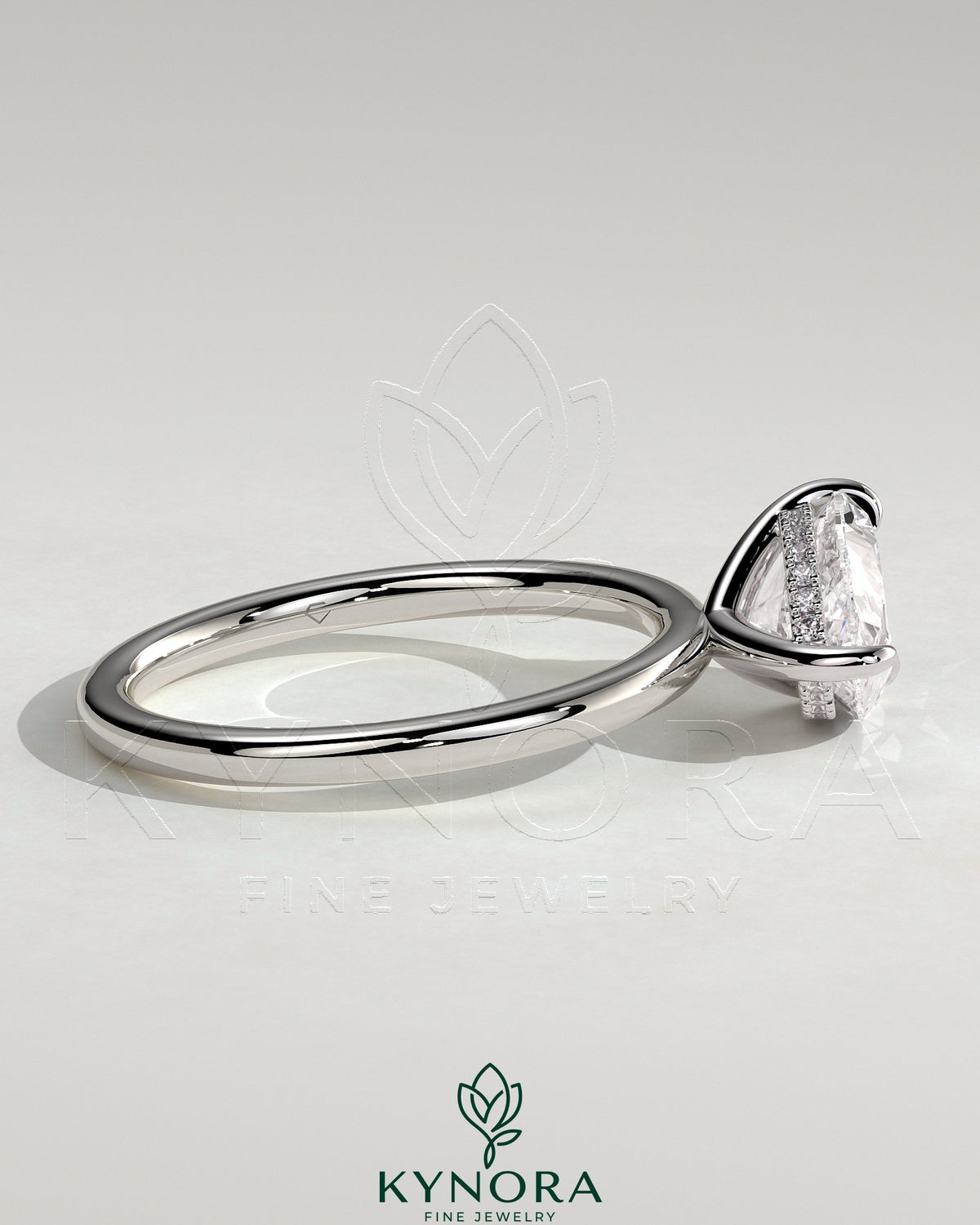 Kynora CJ 2ct pear-shaped East-West claw engagement ring with hidden halo and sparkling diamond accents.